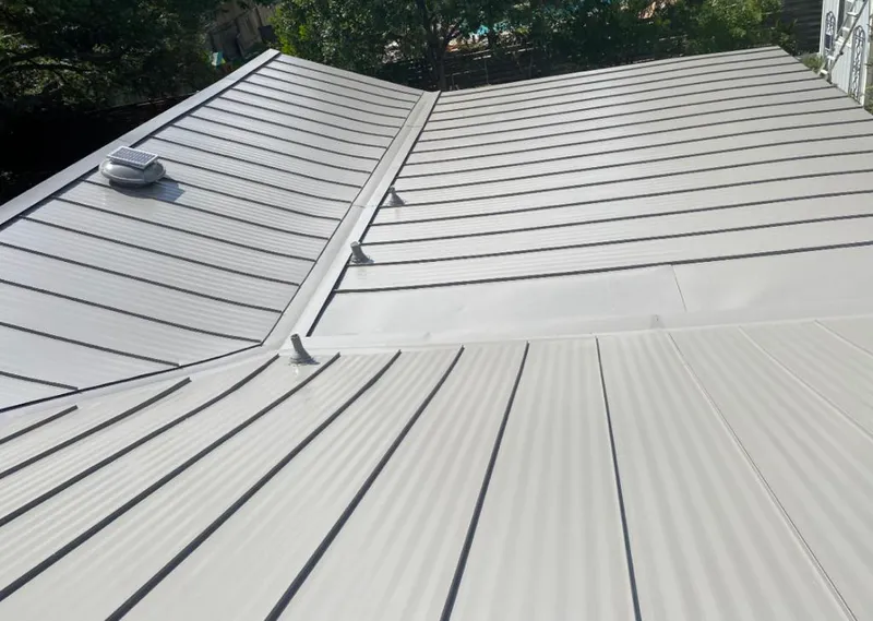 Solar attic fan installed on a metal roof for Roof Ventilation in Owatonna